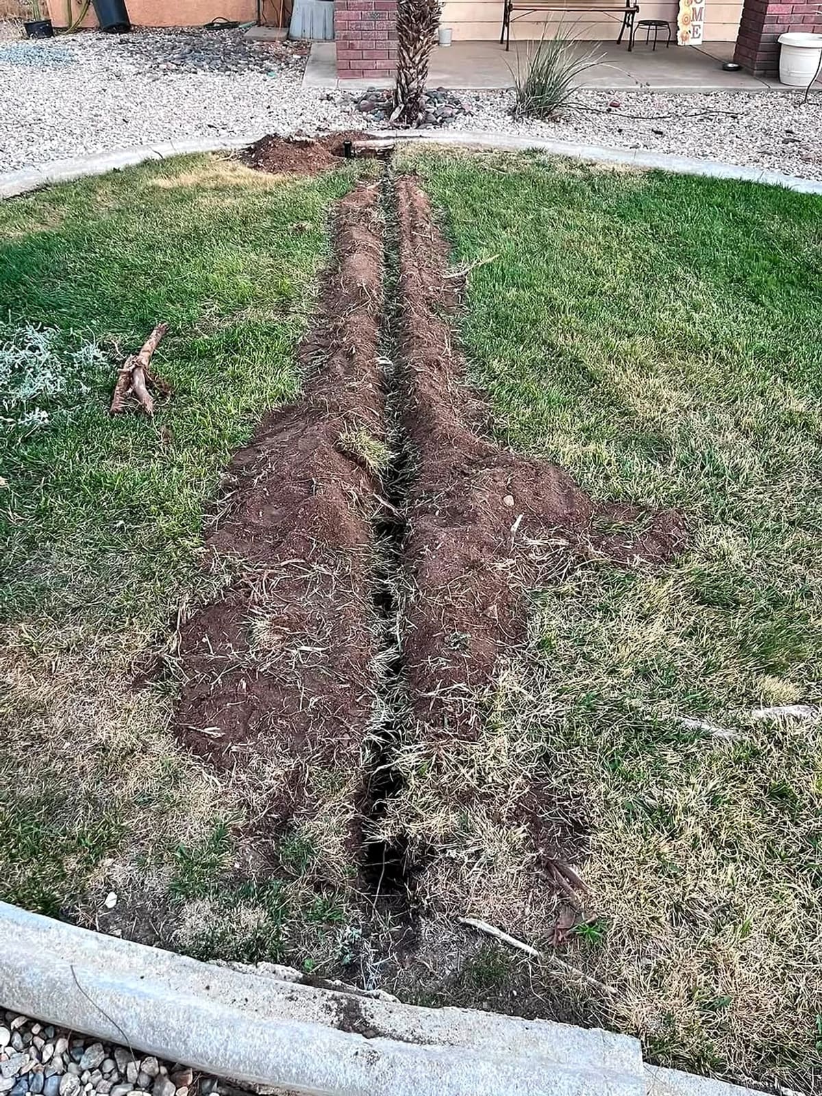 Irrigation trench cut through a lawn